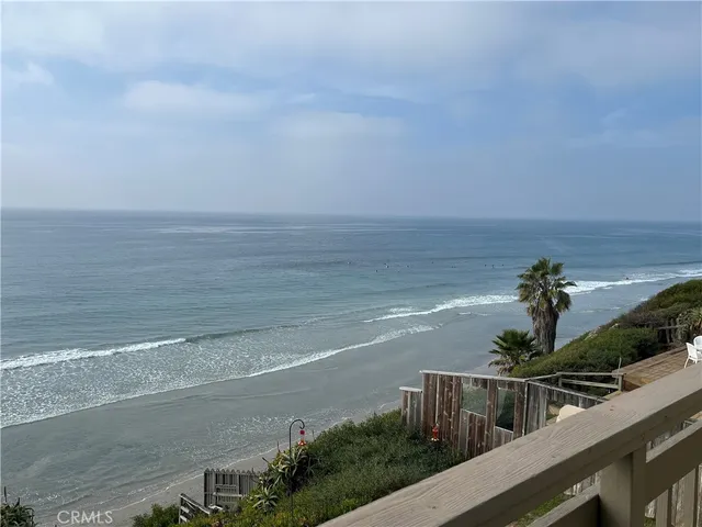 a view of a terrace with wooden floor and a bench