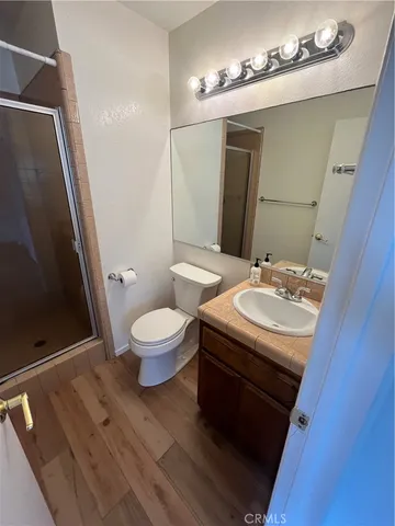 a bathroom with a glass door shower and a sink