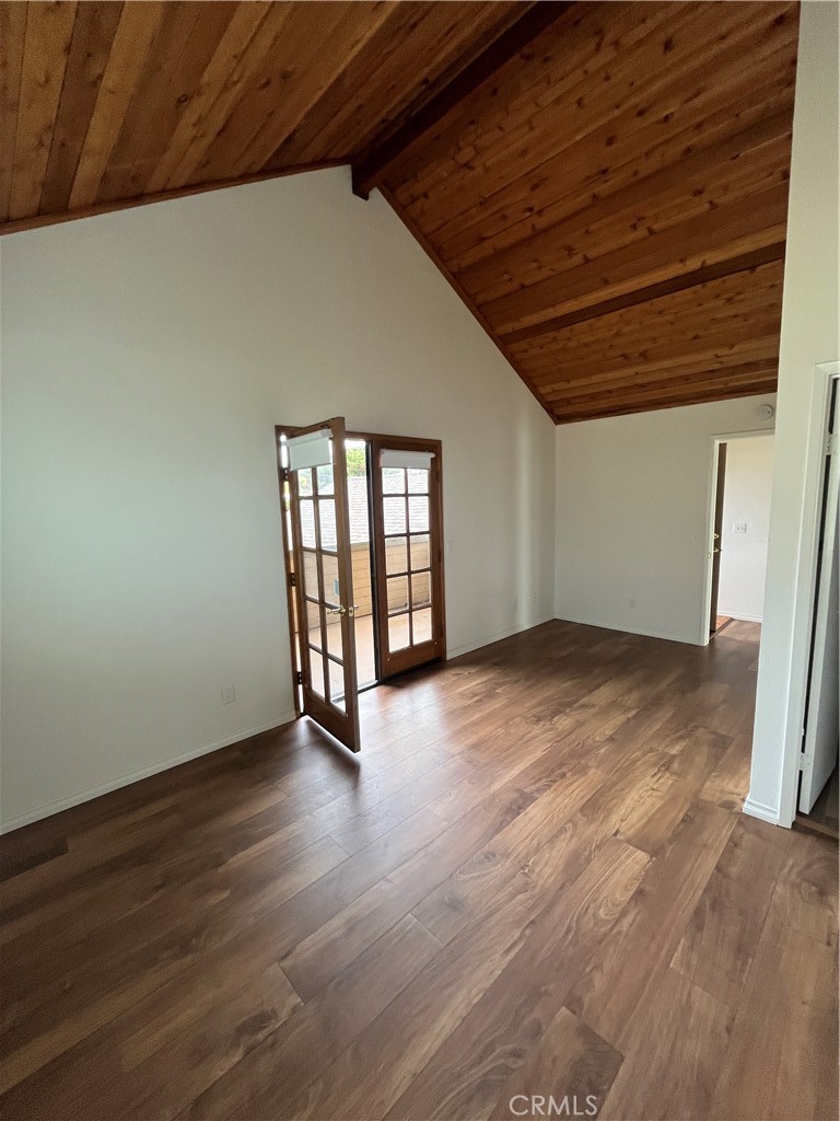 1532 Neptune Avenue Encinitas, CA 92024 - Photo 31 of 36 an empty room with wooden floor and windows