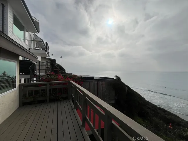 a view of a house with wooden deck