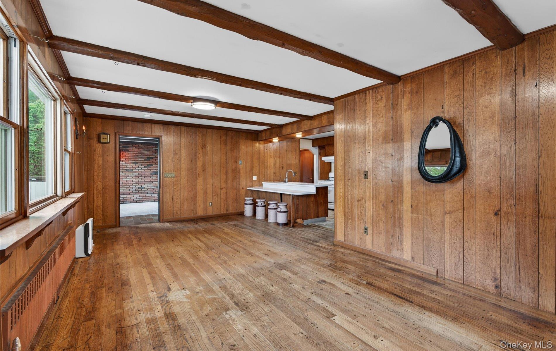 24 Purdue Road Glen Cove, NY 11542 - Photo 16 of 41 a view of a hallway with wooden floor and a bathroom