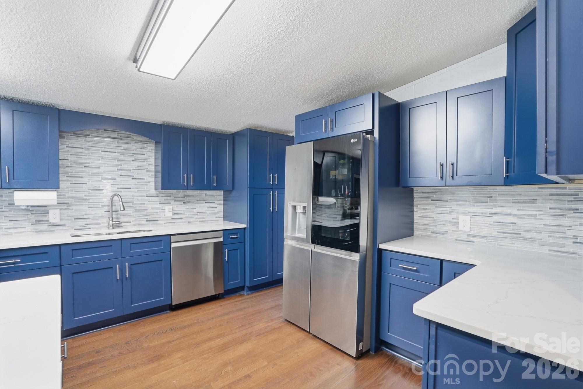 605 Ridgewood Court Mount Holly, NC 28120 - Photo 3 of 32 a kitchen with stainless steel appliances granite countertop a sink and a refrigerator