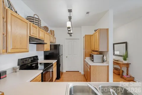 a bedroom with a bed and chandelier