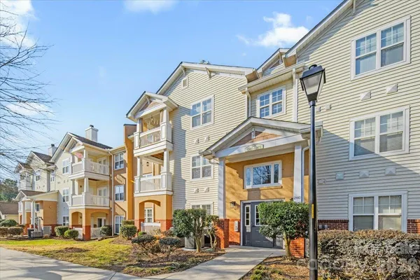 a front view of a residential apartment building with a yard
