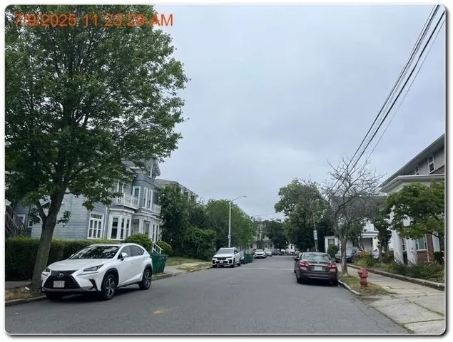 a view of cars parked on the side of a street