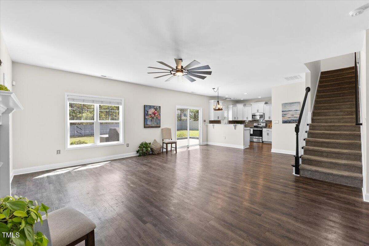 166 Old Field Loop Sanford, NC 27332 - Photo 10 of 50 a view of a livingroom with furniture hardwood floor and a ceiling fan