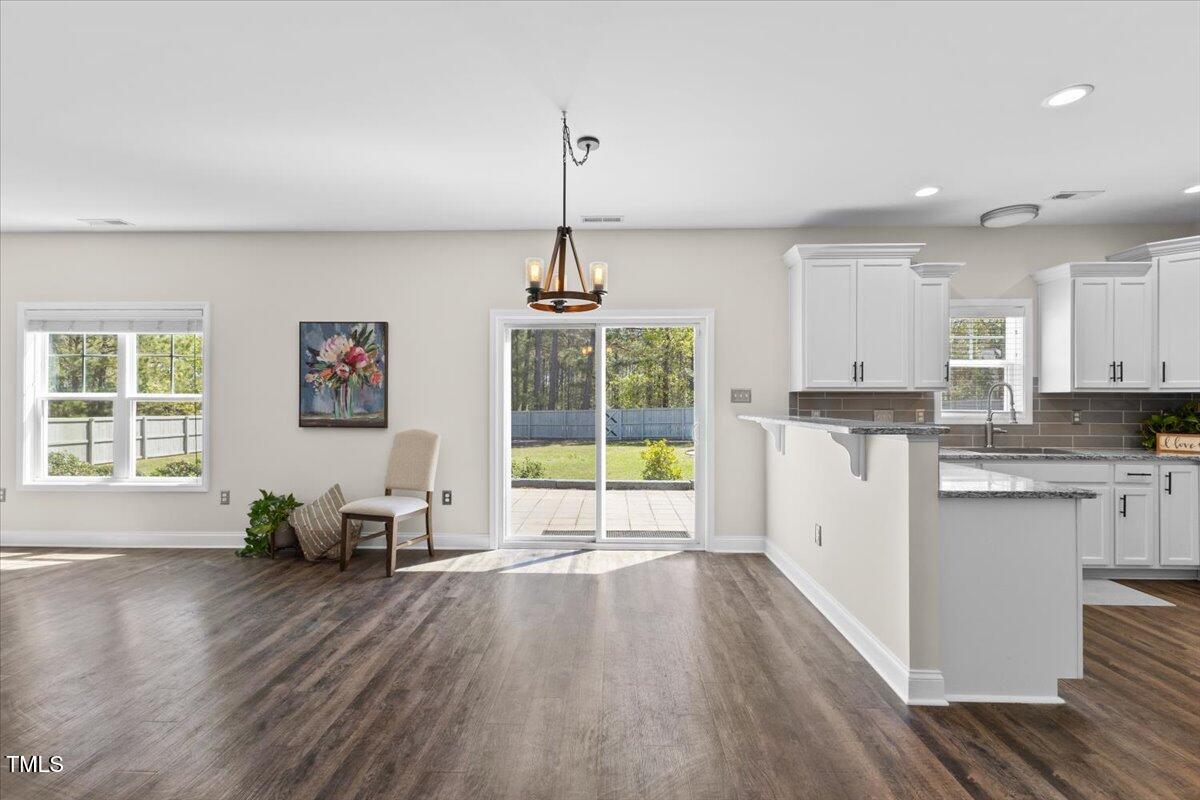 166 Old Field Loop Sanford, NC 27332 - Photo 11 of 50 a living room with stainless steel appliances granite countertop furniture and a wooden floor