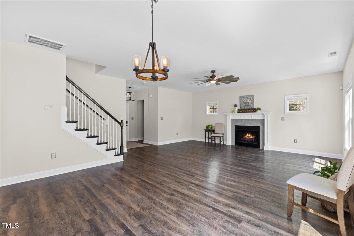 166 Old Field Loop Sanford, NC 27332 - Photo 12 of 50 a view of empty room with wooden floor and fireplace