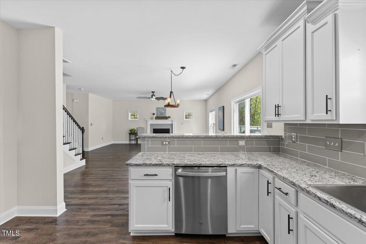 166 Old Field Loop Sanford, NC 27332 - Photo 17 of 50 a kitchen with granite countertop a sink stove and cabinets