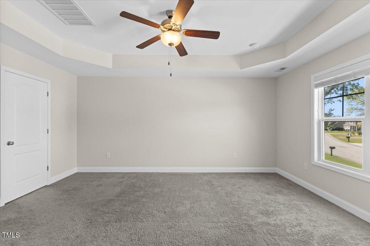 166 Old Field Loop Sanford, NC 27332 - Photo 26 of 50 an empty room with a window and a fan