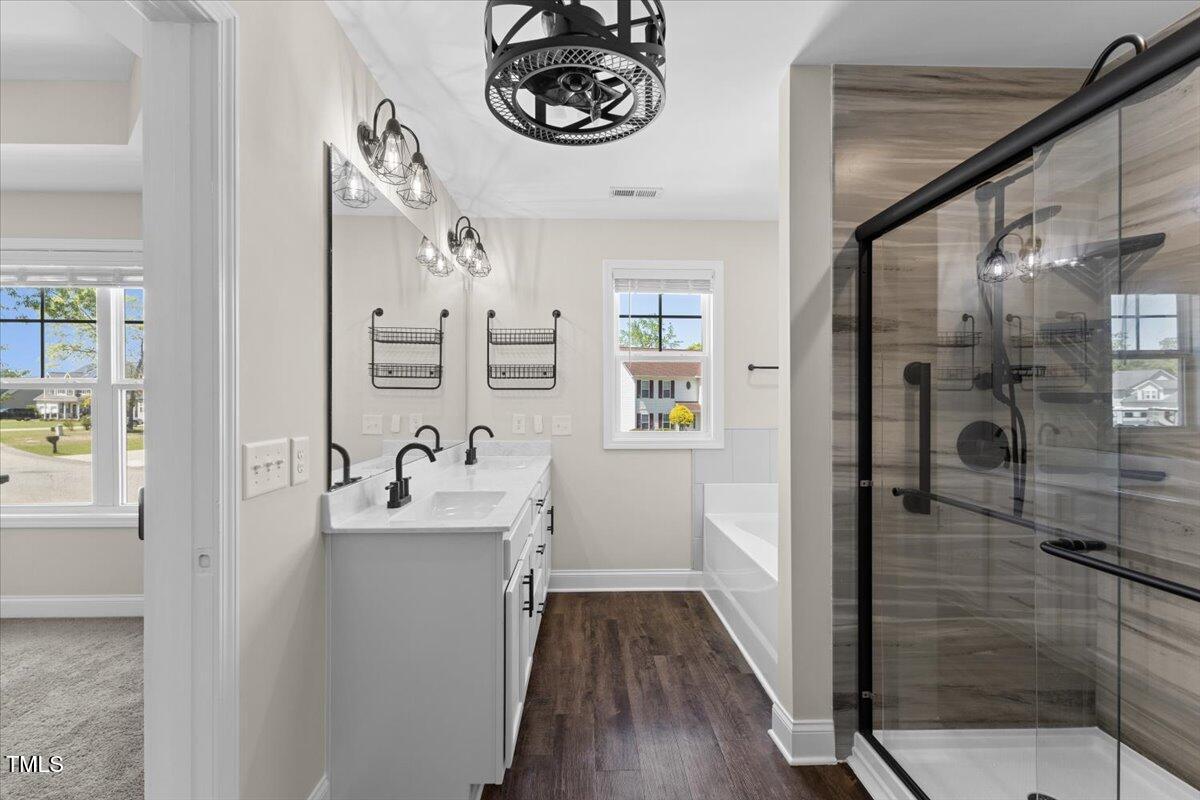 166 Old Field Loop Sanford, NC 27332 - Photo 27 of 50 a bathroom with a sink a mirror and a shower