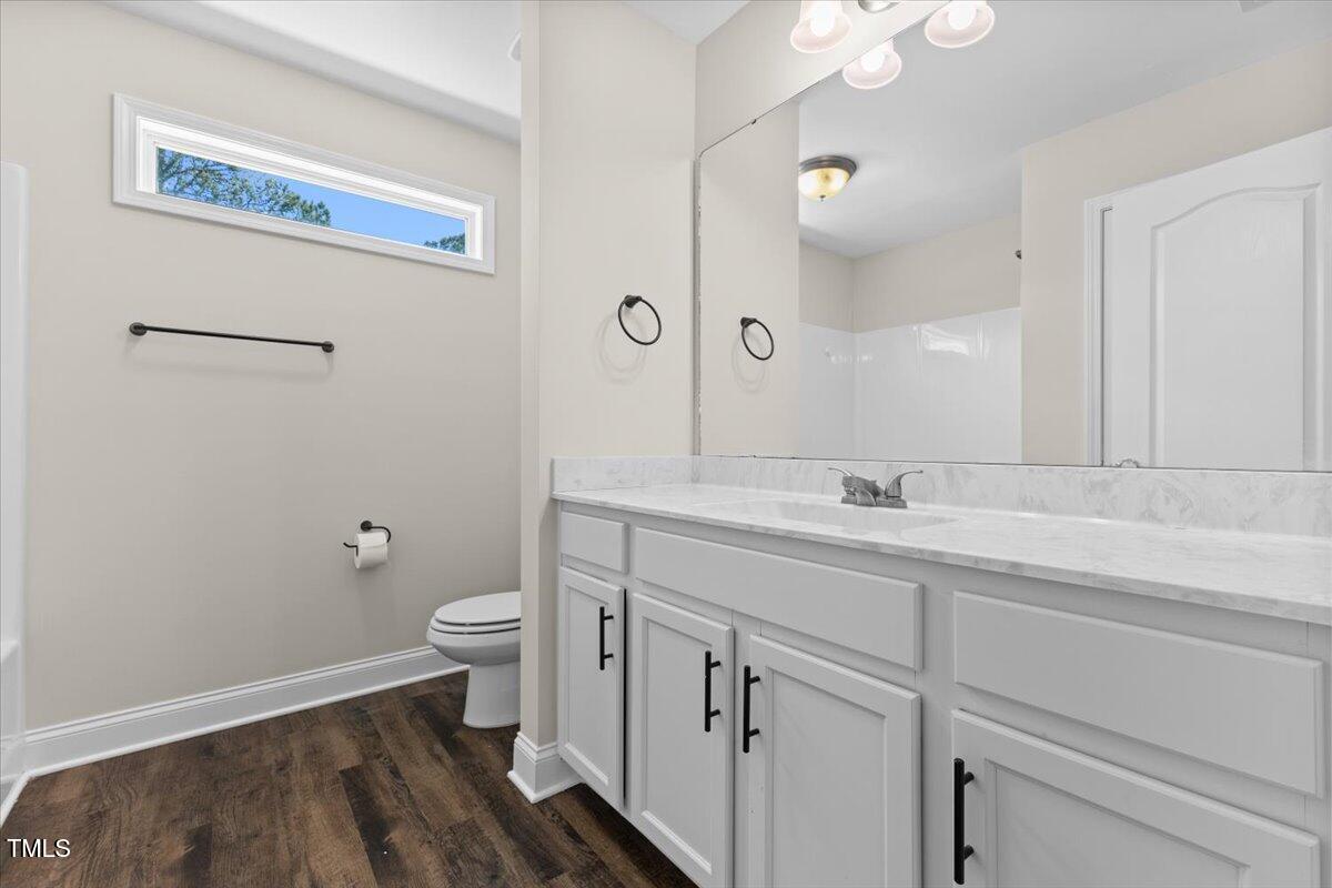 166 Old Field Loop Sanford, NC 27332 - Photo 35 of 50 a bathroom with a sink a toilet and a mirror