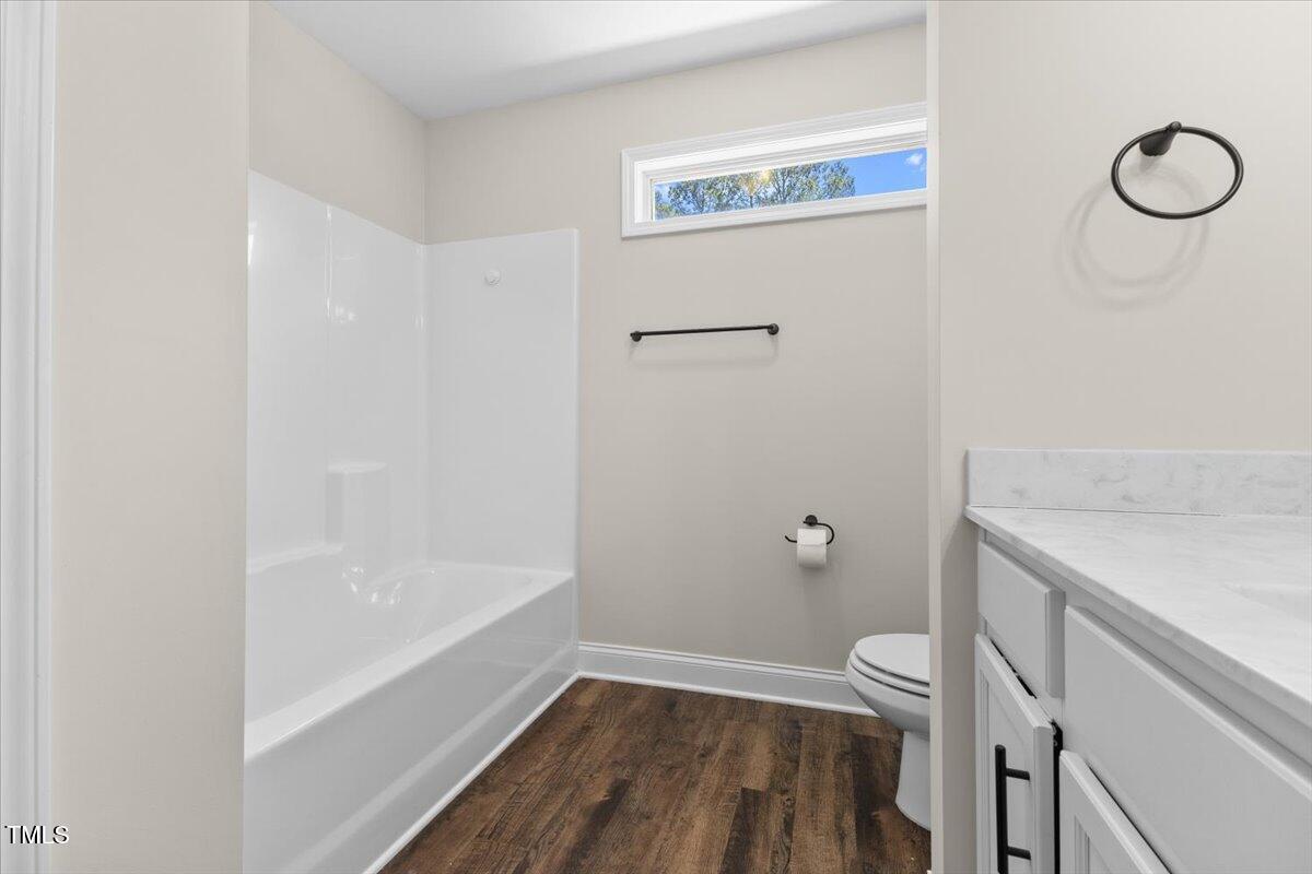 166 Old Field Loop Sanford, NC 27332 - Photo 36 of 50 a bathroom with a granite countertop sink and a mirror