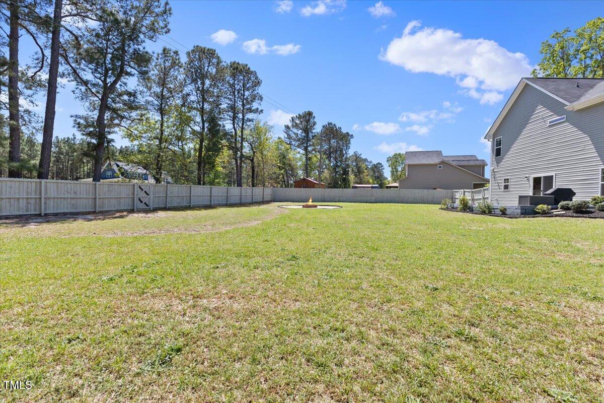 166 Old Field Loop Sanford, NC 27332 - Photo 47 of 50 a swimming pool with outdoor seating and yard