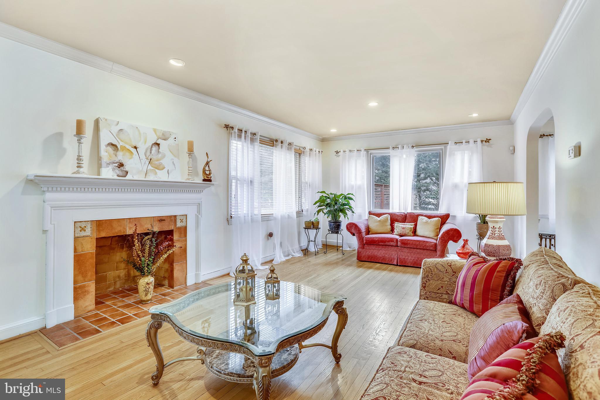 Sun-lit Living Room  with Tiled front Fireplace