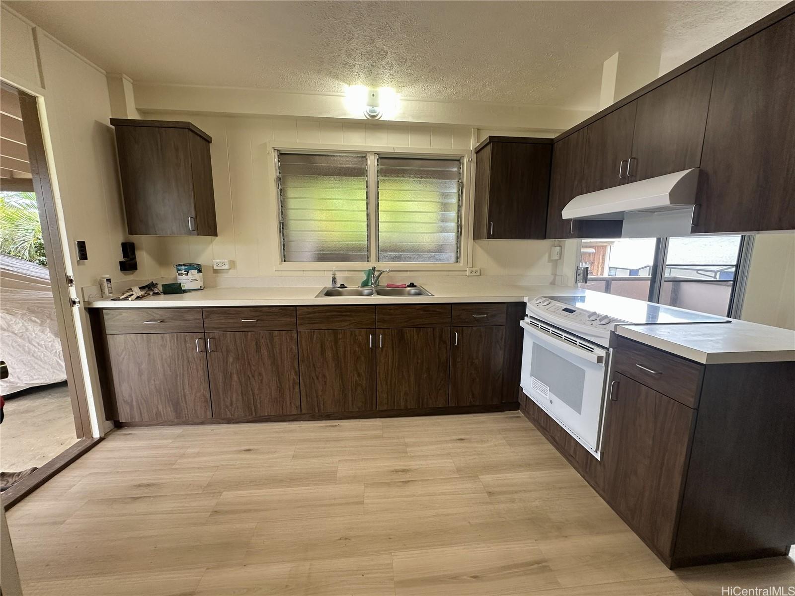 45-038 Waikalua Road Kaneohe, HI 96744 - Photo 5 of 16 a kitchen with a sink a stove and cabinets
