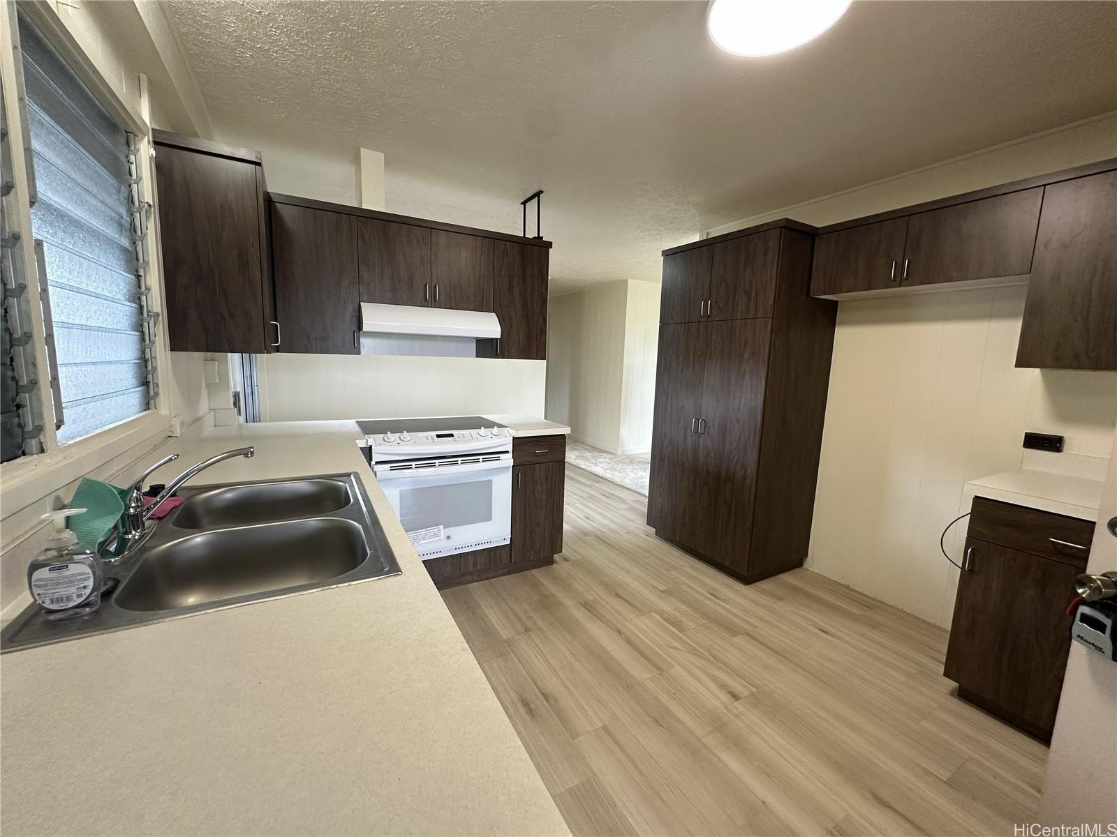 45-038 Waikalua Road Kaneohe, HI 96744 - Photo 6 of 16 a kitchen that has a sink and a refrigerator
