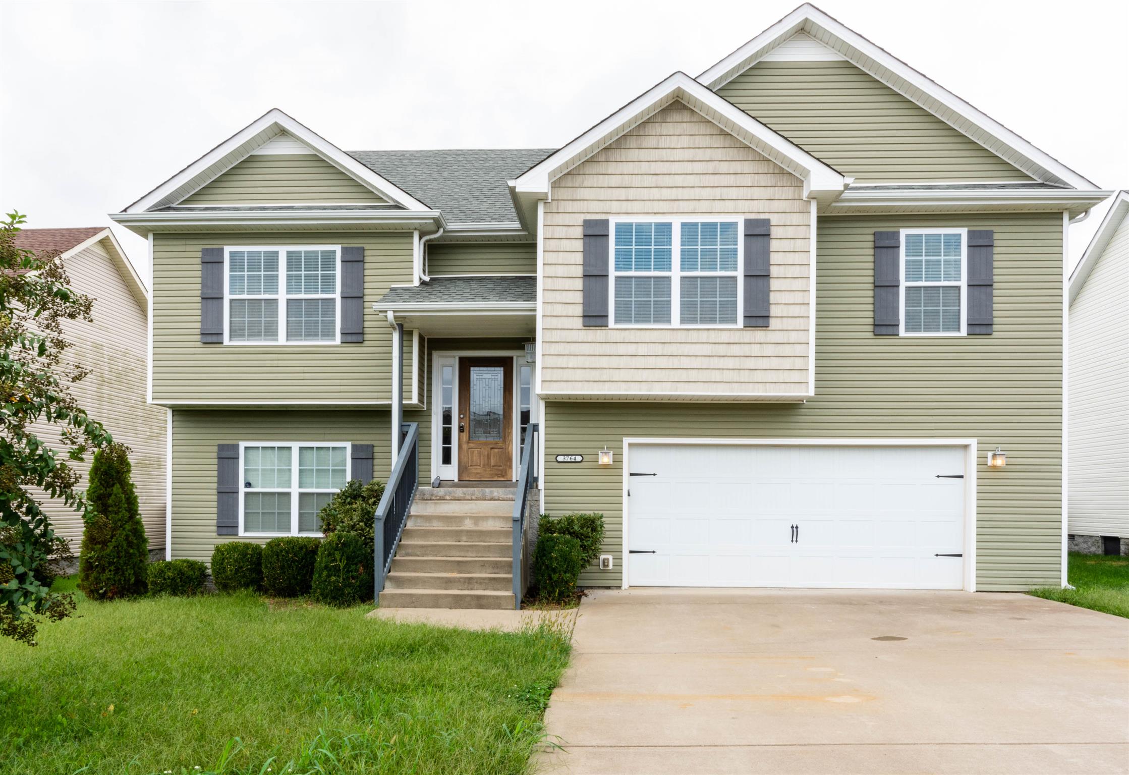 3764 Suiter Road Clarksville, TN 37040 - Photo 1 of 18 a front view of a house with a yard and garage