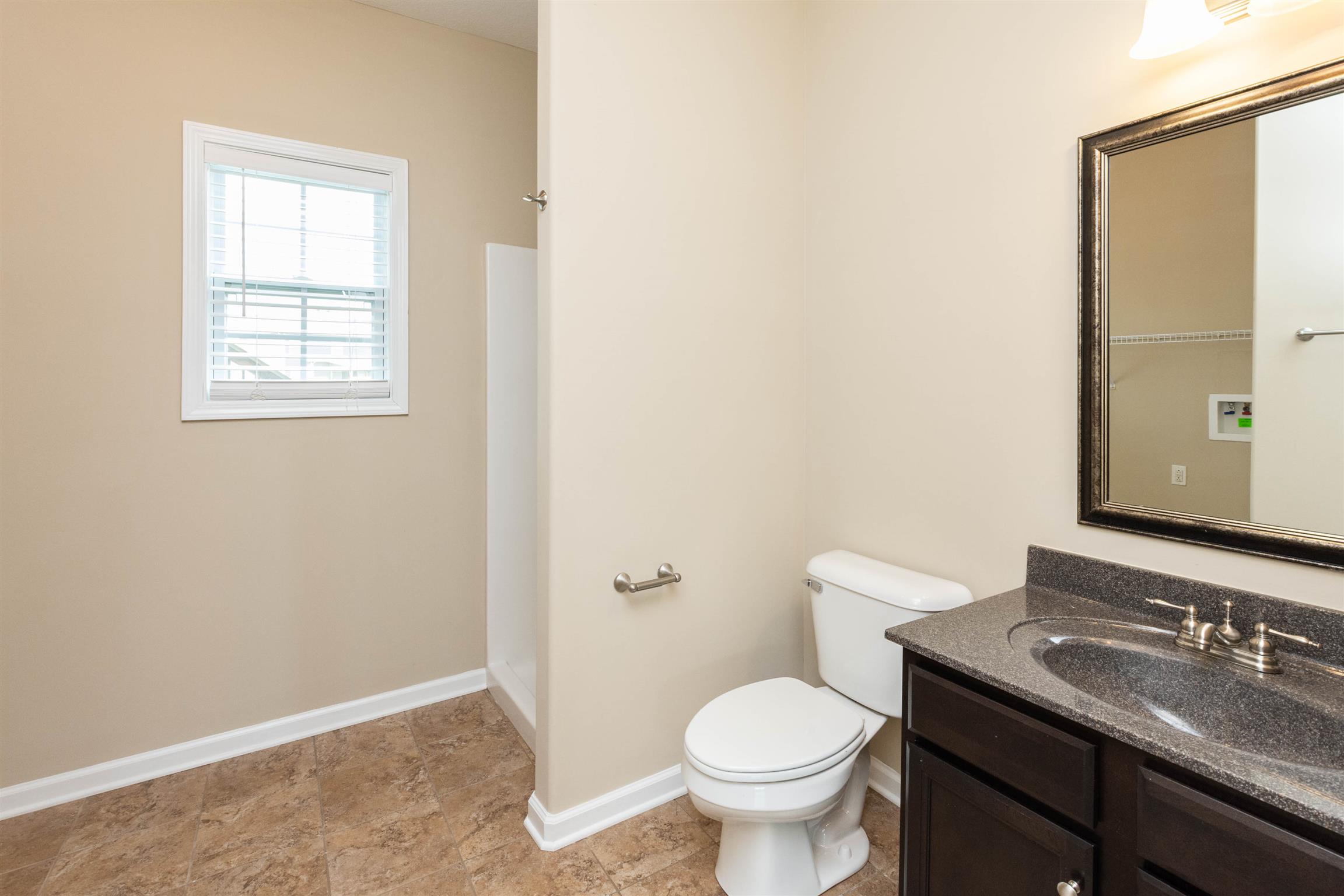 3764 Suiter Road Clarksville, TN 37040 - Photo 15 of 18 a bathroom with a granite countertop sink toilet and mirror