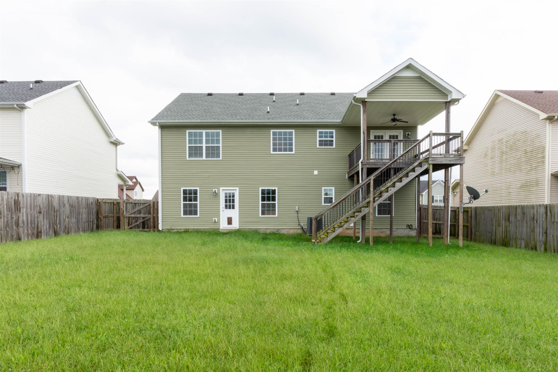 3764 Suiter Road Clarksville, TN 37040 - Photo 18 of 18 a house that has a big yard and a wooden fence