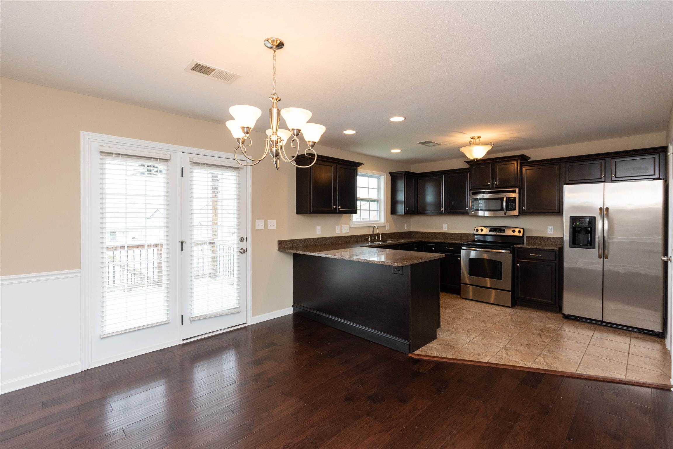 3764 Suiter Road Clarksville, TN 37040 - Photo 4 of 18 a kitchen with granite countertop stainless steel appliances a counter top space cabinets and a large window