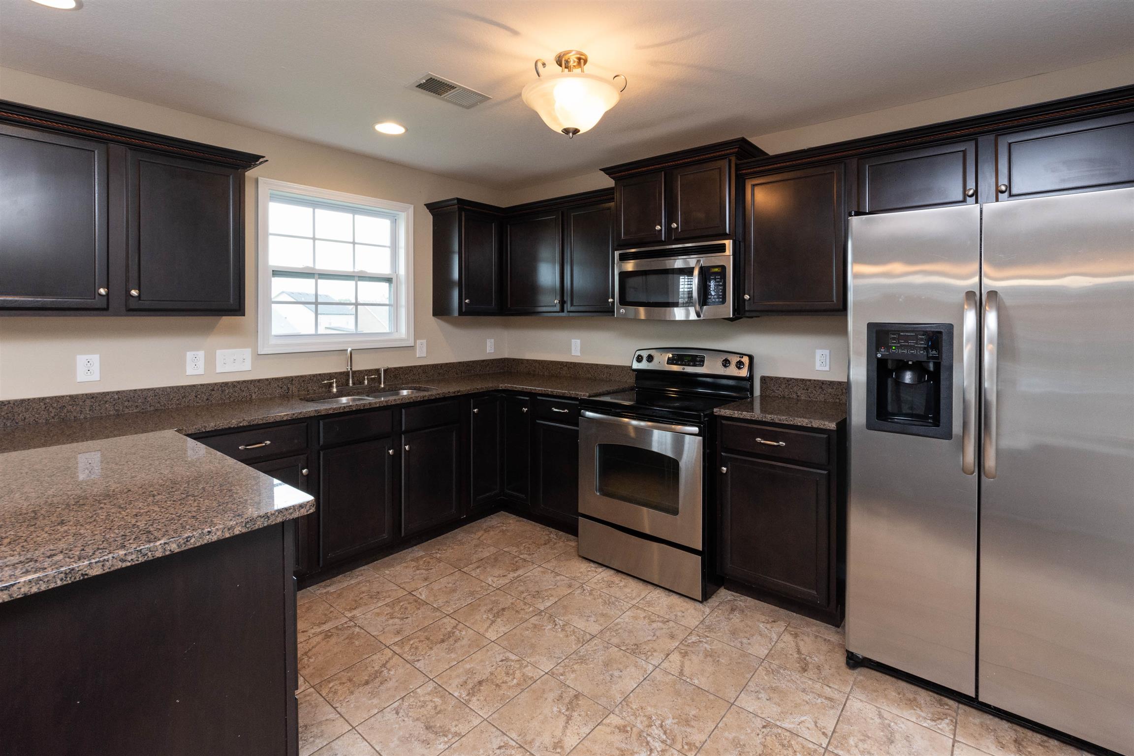 3764 Suiter Road Clarksville, TN 37040 - Photo 5 of 18 a kitchen with stainless steel appliances granite countertop a sink stove and refrigerator