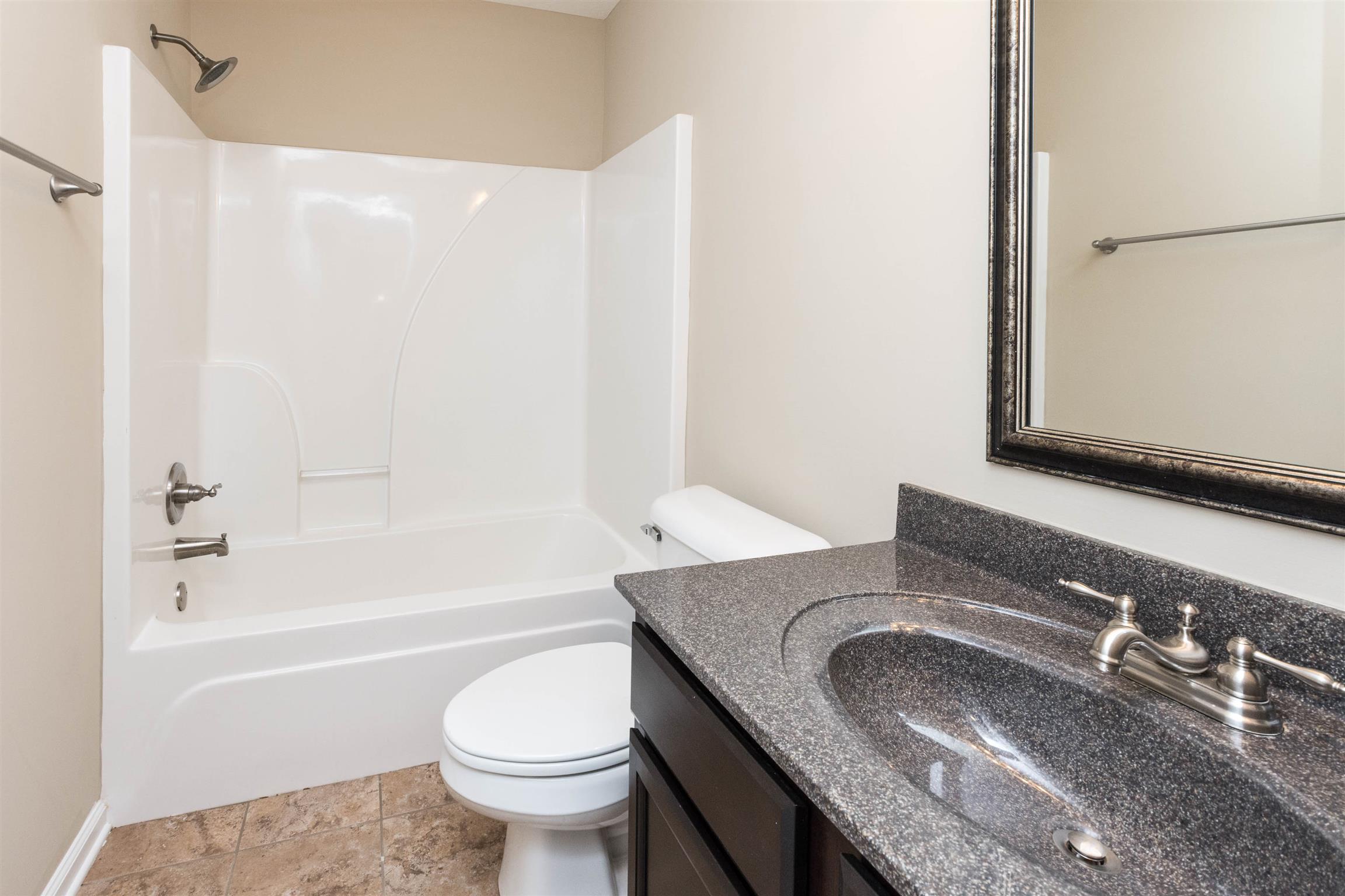 3764 Suiter Road Clarksville, TN 37040 - Photo 6 of 18 a bathroom with a granite countertop sink toilet and shower