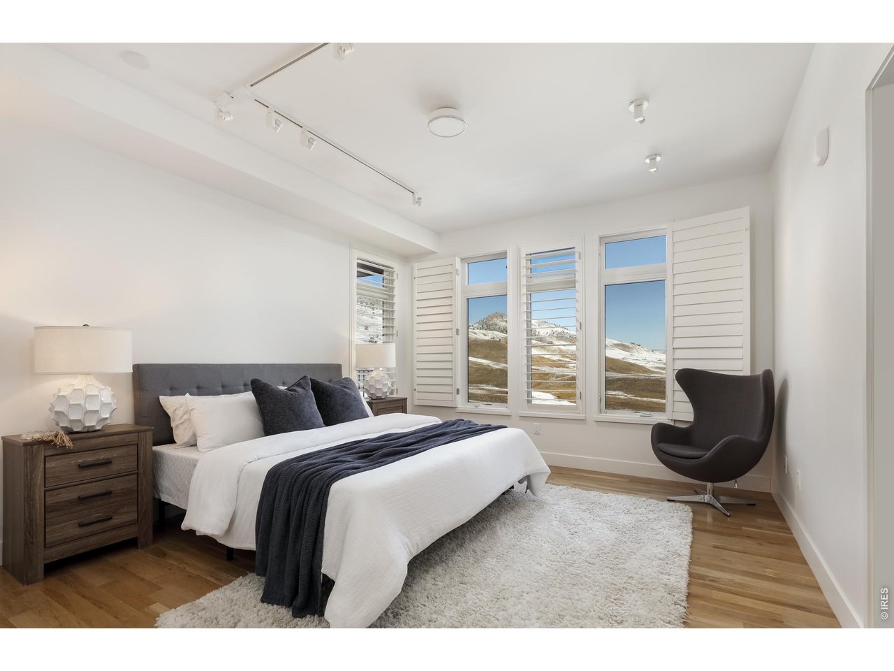 650 Terrace Avenue, Unit E Boulder, CO 80304 - Photo 12 of 44 a spacious bedroom with a bed a couch and large window