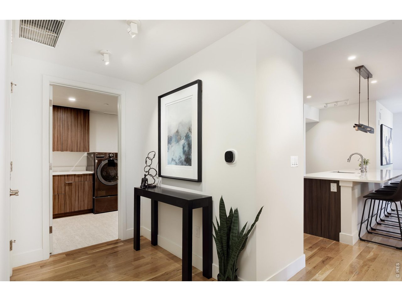 650 Terrace Avenue, Unit E Boulder, CO 80304 - Photo 31 of 44 a living room with stainless steel appliances kitchen island granite countertop a refrigerator a sink a stove and white cabinets with wooden floor