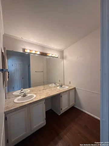 a bathroom with a double vanity sink and mirror