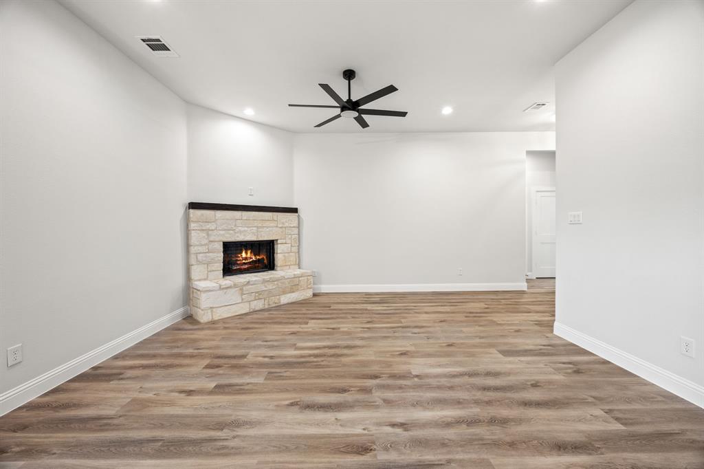 104 Maverick Trail Valley View, TX 76272 - Photo 6 of 30 a view of an empty room with a fireplace and a window