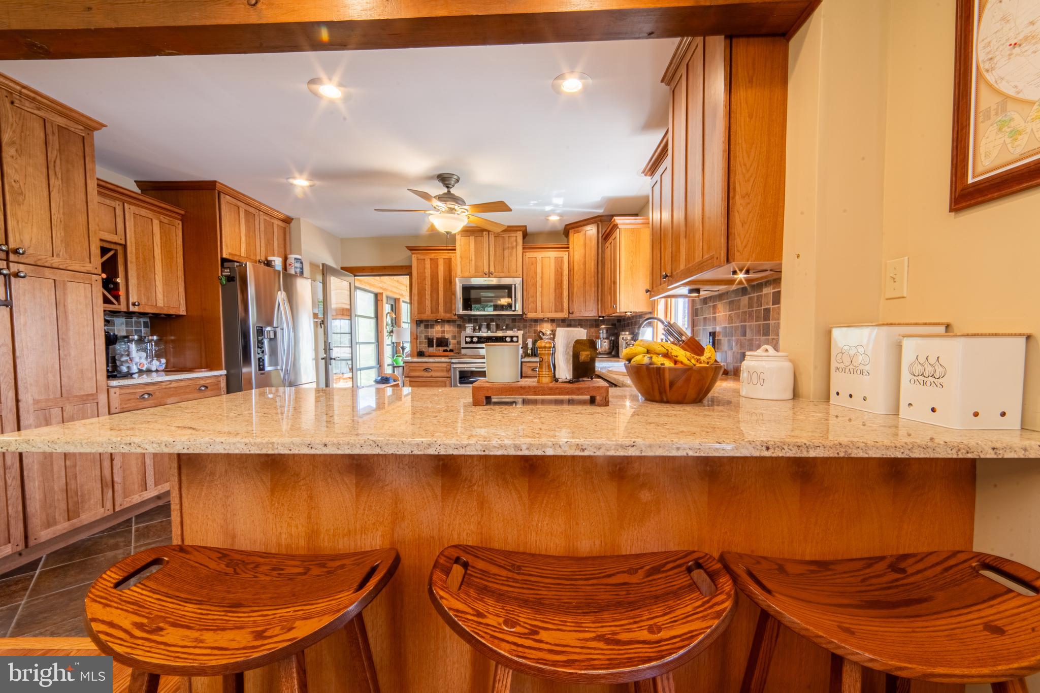125 Cruzan Road Bridgeton, NJ 08302 - Photo 36 of 47 a kitchen with stainless steel appliances kitchen island granite countertop a table and chairs