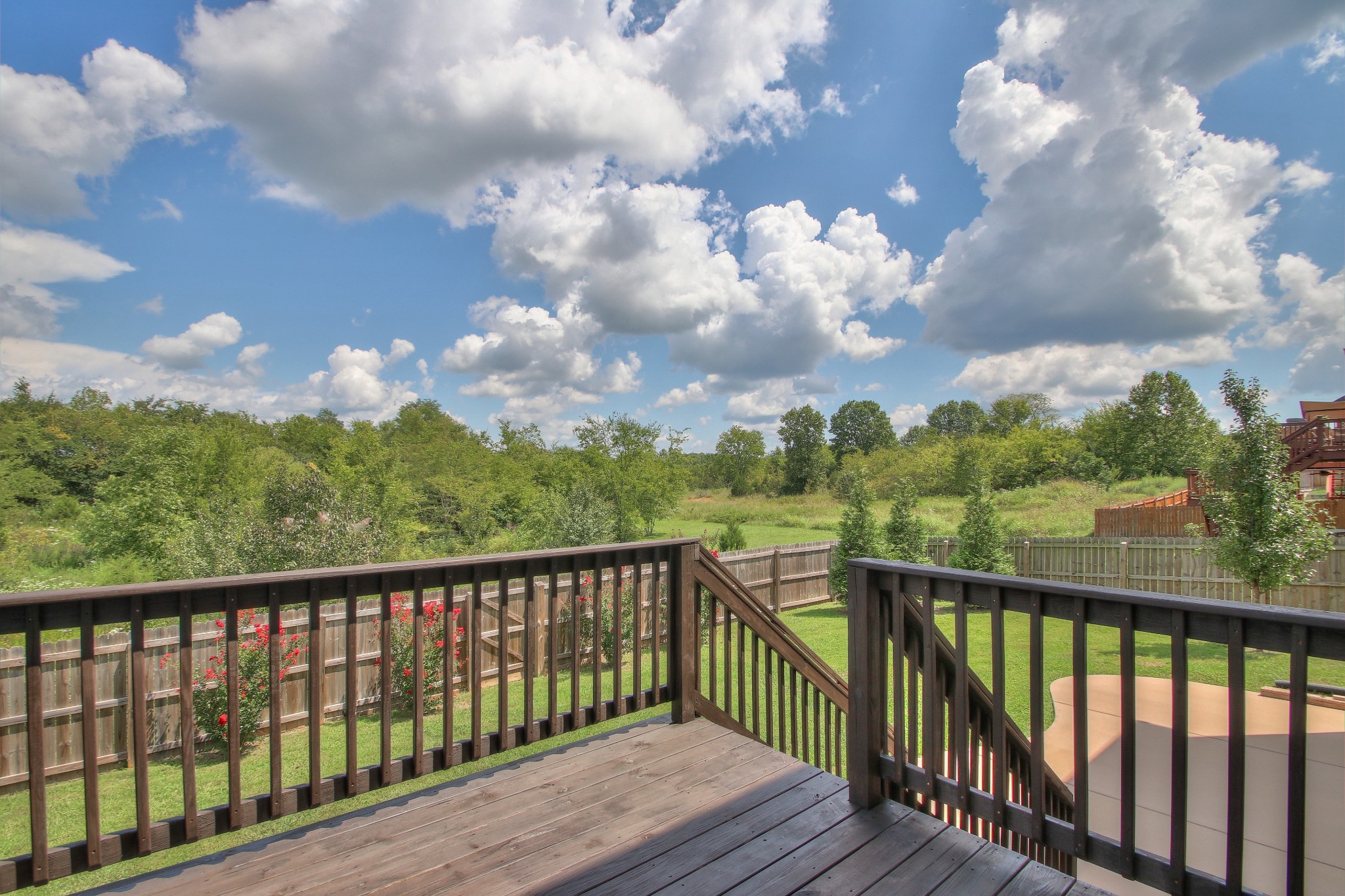 2025 Lincoln Road Spring Hill, TN 37174 - Photo 1 of 37 a balcony with wooden floor and trees in back