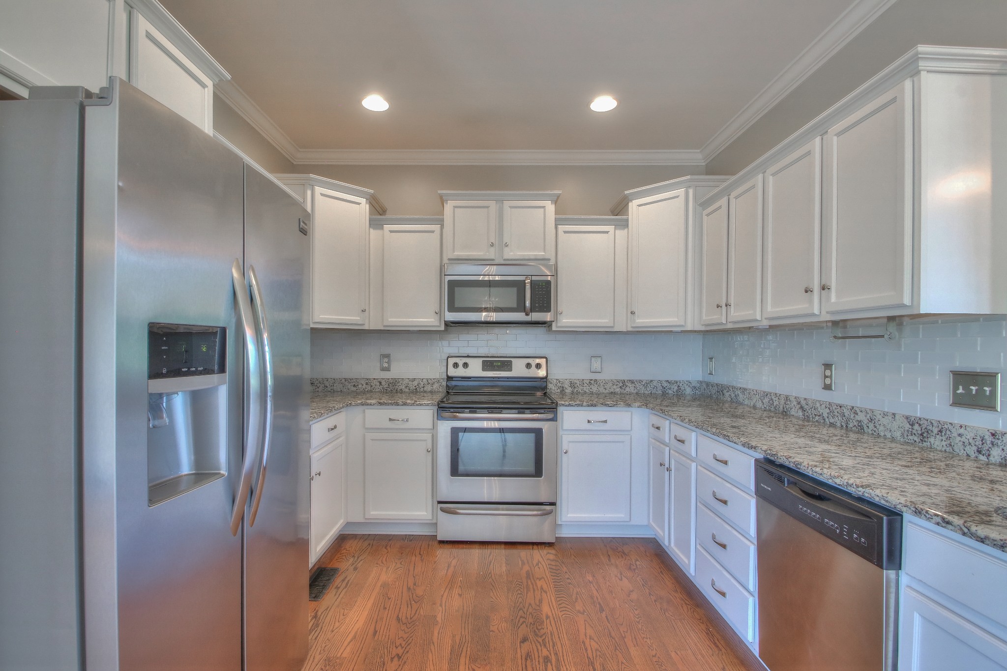2025 Lincoln Road Spring Hill, TN 37174 - Photo 11 of 37 a kitchen with stainless steel appliances granite countertop a stove a sink and a refrigerator