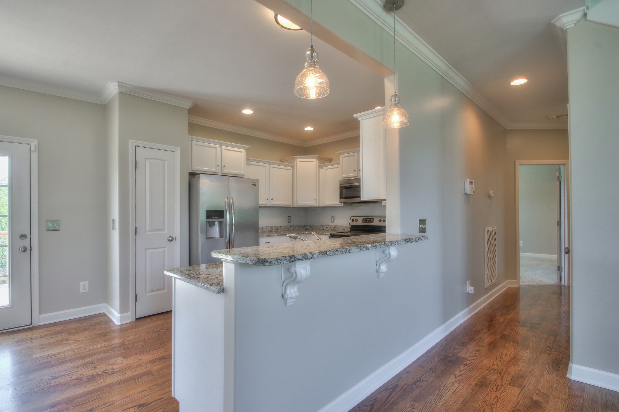 2025 Lincoln Road Spring Hill, TN 37174 - Photo 13 of 37 a kitchen with kitchen island granite countertop a refrigerator and a sink