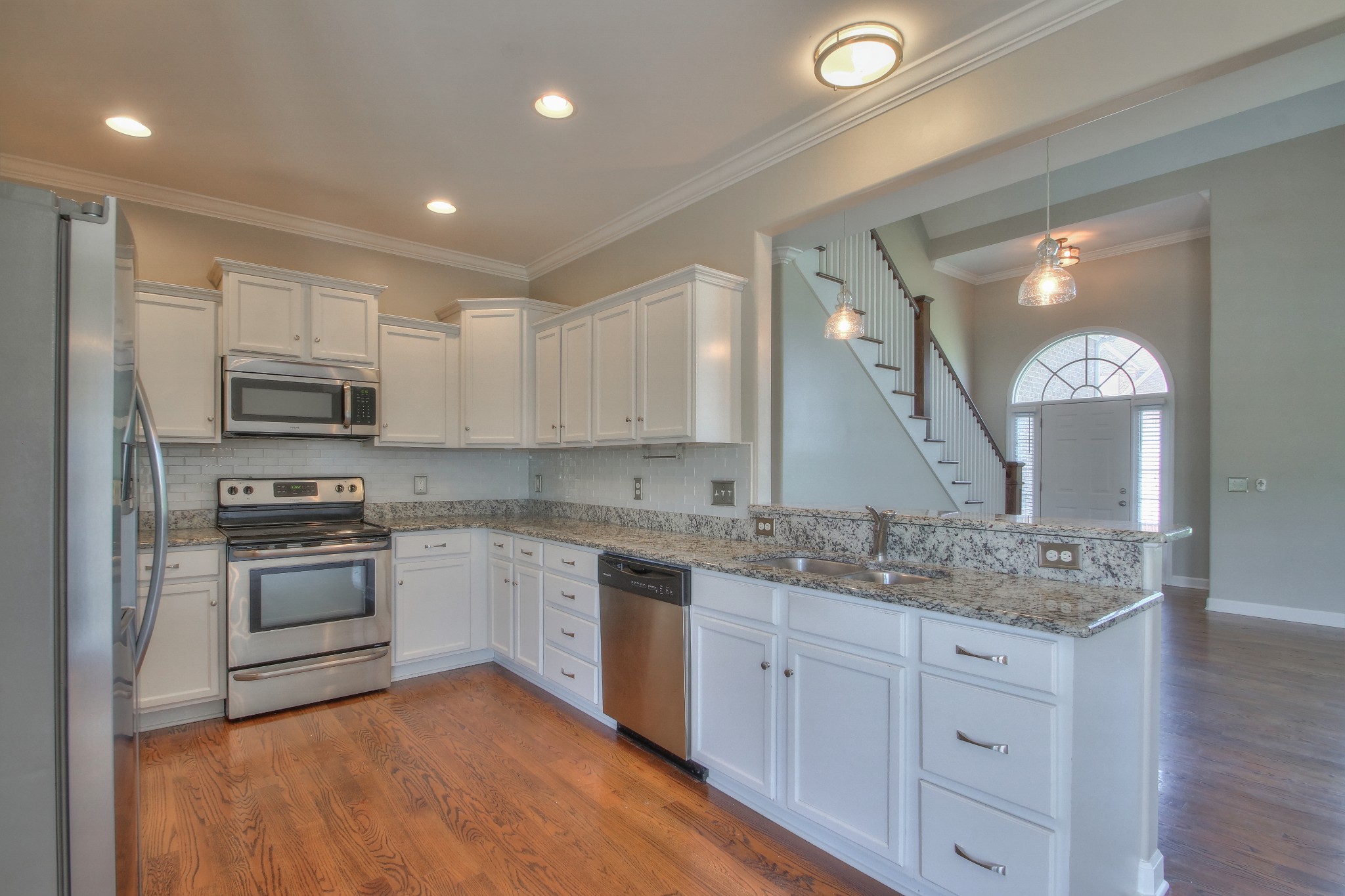 2025 Lincoln Road Spring Hill, TN 37174 - Photo 14 of 37 a kitchen with stainless steel appliances granite countertop a sink and cabinets