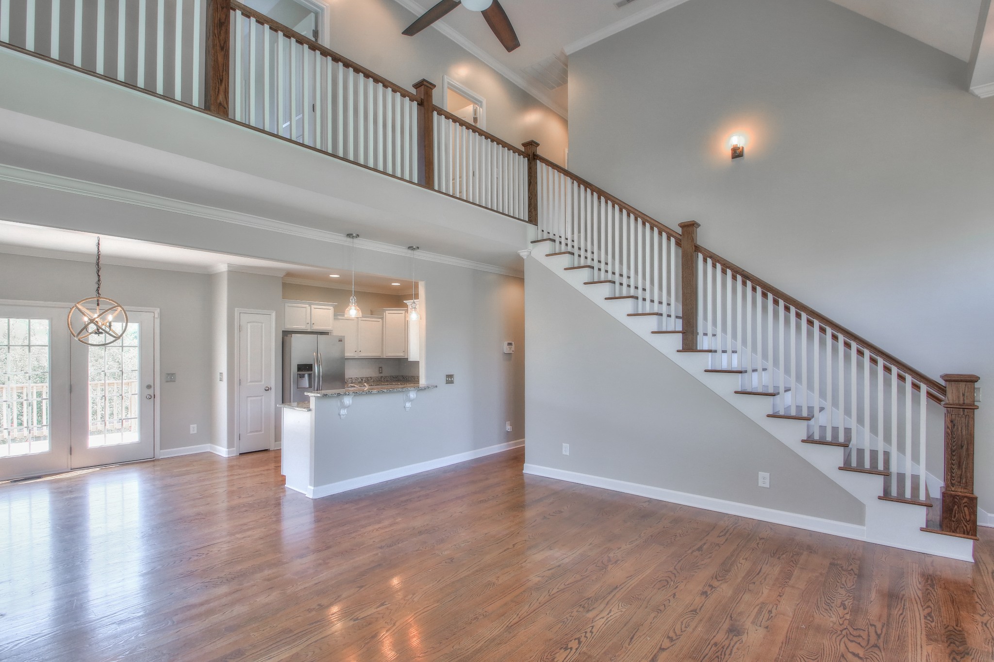 2025 Lincoln Road Spring Hill, TN 37174 - Photo 6 of 37 a view of a hallway with wooden floor and staircase