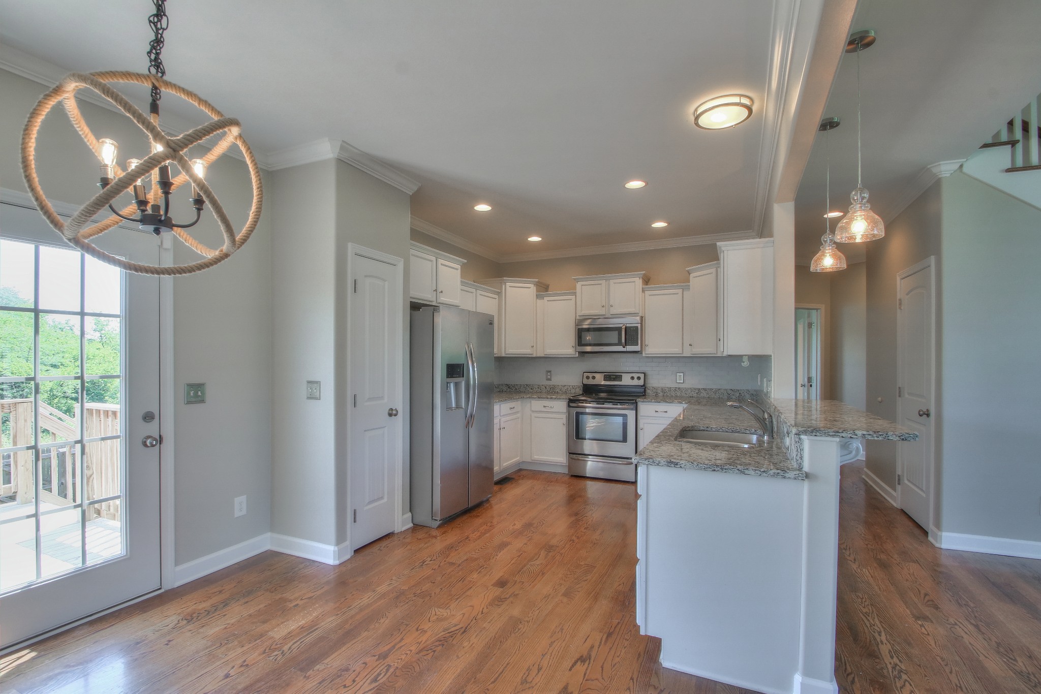 2025 Lincoln Road Spring Hill, TN 37174 - Photo 10 of 37 a kitchen with stainless steel appliances granite countertop a refrigerator a stove and a wooden floors