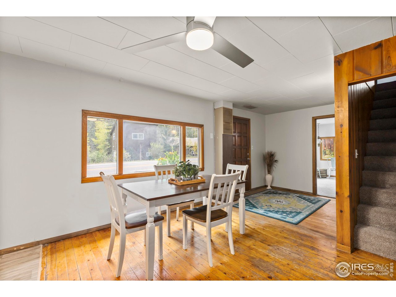 2387 West W Highway Drake, CO 80515 - Photo 11 of 29 a view of a dining room with furniture wooden floor and a carpet