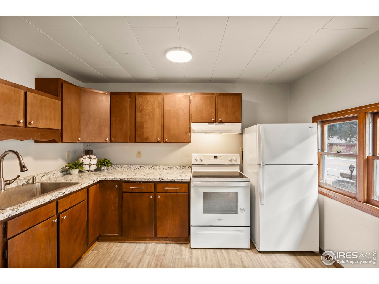 2387 West W Highway Drake, CO 80515 - Photo 13 of 29 a kitchen with a sink a stove a refrigerator and cabinets