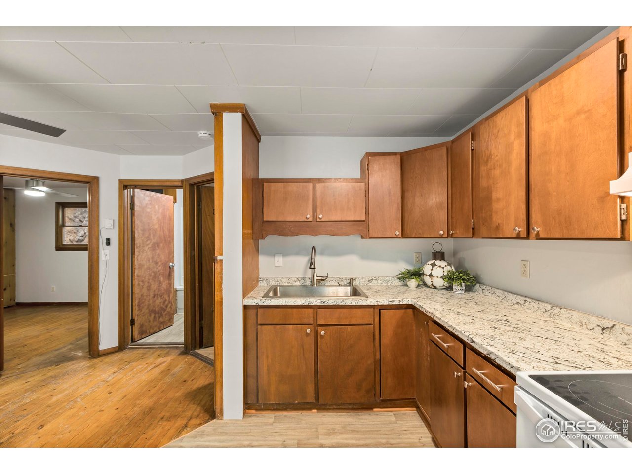 2387 West W Highway Drake, CO 80515 - Photo 15 of 29 a kitchen with a sink a stove and cabinets