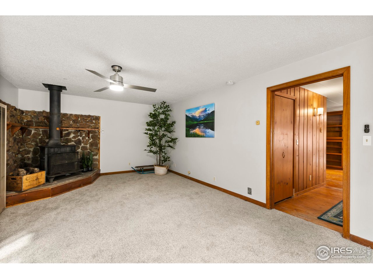 2387 West W Highway Drake, CO 80515 - Photo 18 of 29 a view of a livingroom with an empty room and wooden floor