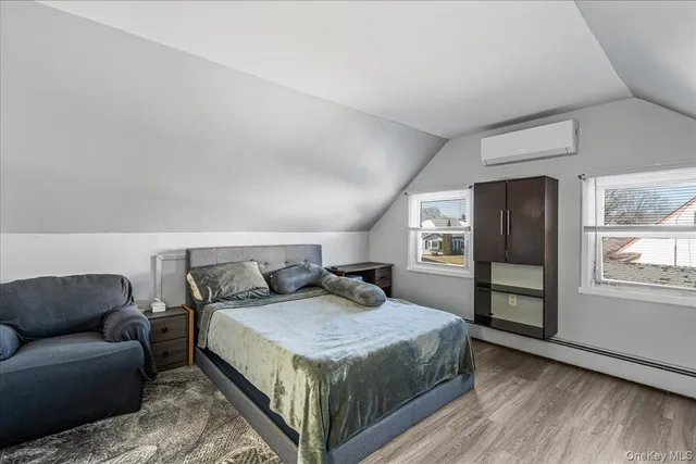 a bedroom with a bed couch and a window