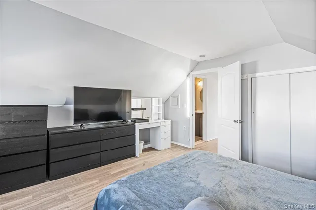 a bedroom with a bed and a flat screen tv