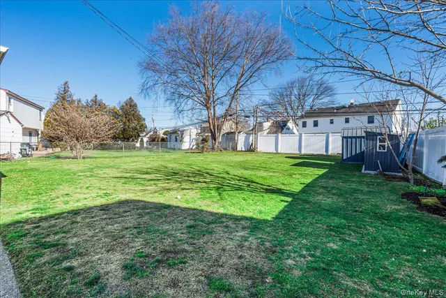 a view of a yard with a house in the background