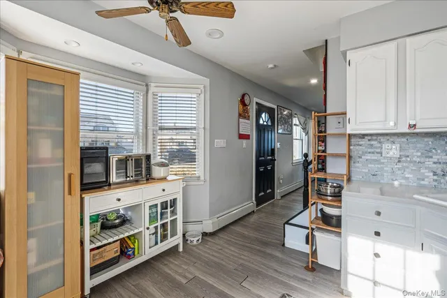a view of an entryway with wooden floor