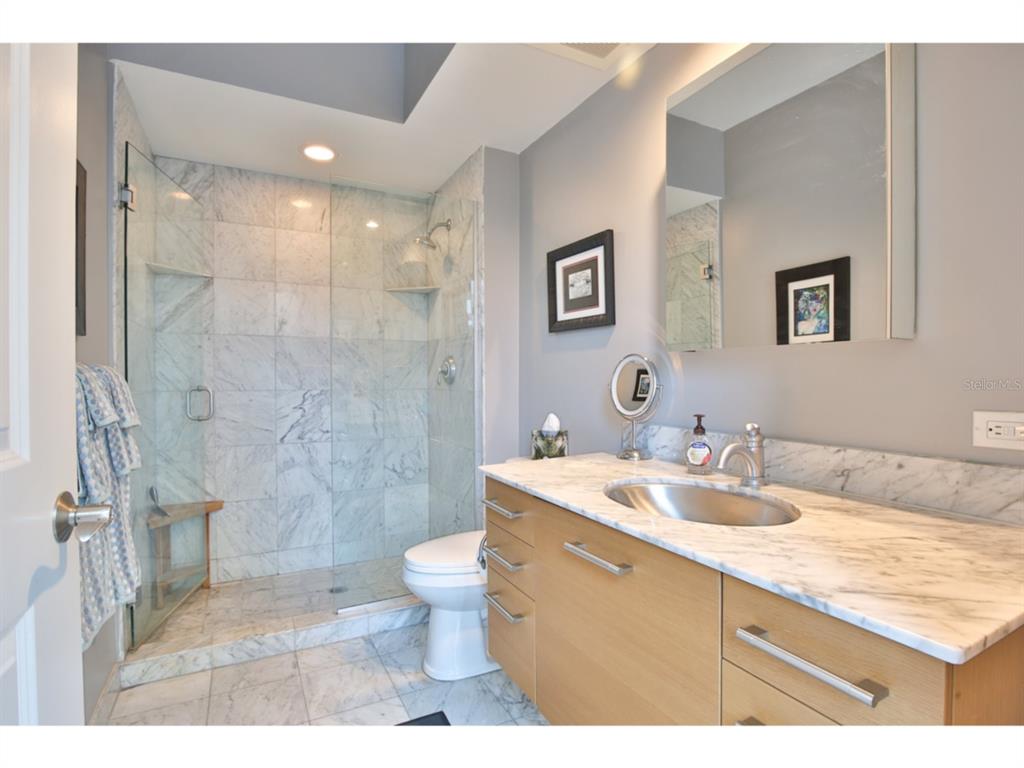 1350 Main Street, Unit 204 Sarasota, FL 34236 - Photo 15 of 22 a bathroom with a sink toilet double vanity and shower