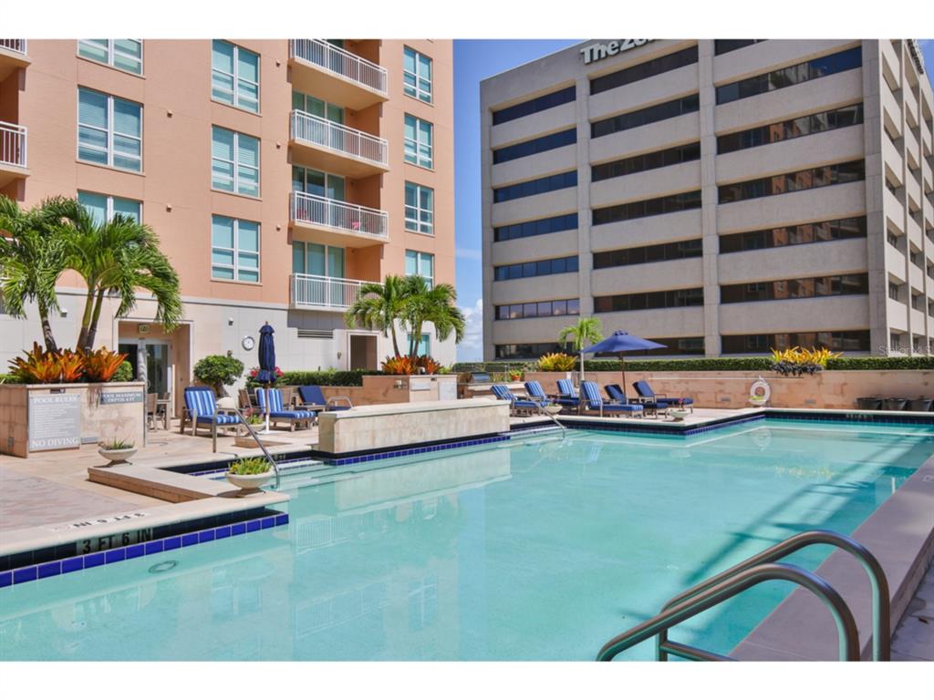 1350 Main Street, Unit 204 Sarasota, FL 34236 - Photo 20 of 22 a swimming pool with outdoor seating and yard