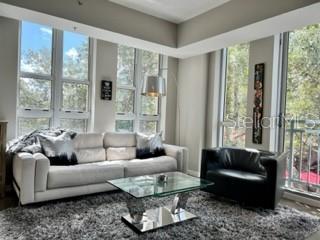 1350 Main Street, Unit 204 Sarasota, FL 34236 - Photo 4 of 22 a living room with furniture and a large window