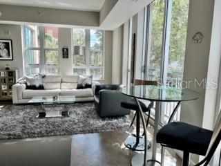 1350 Main Street, Unit 204 Sarasota, FL 34236 - Photo 5 of 22 a living room with furniture and a large window